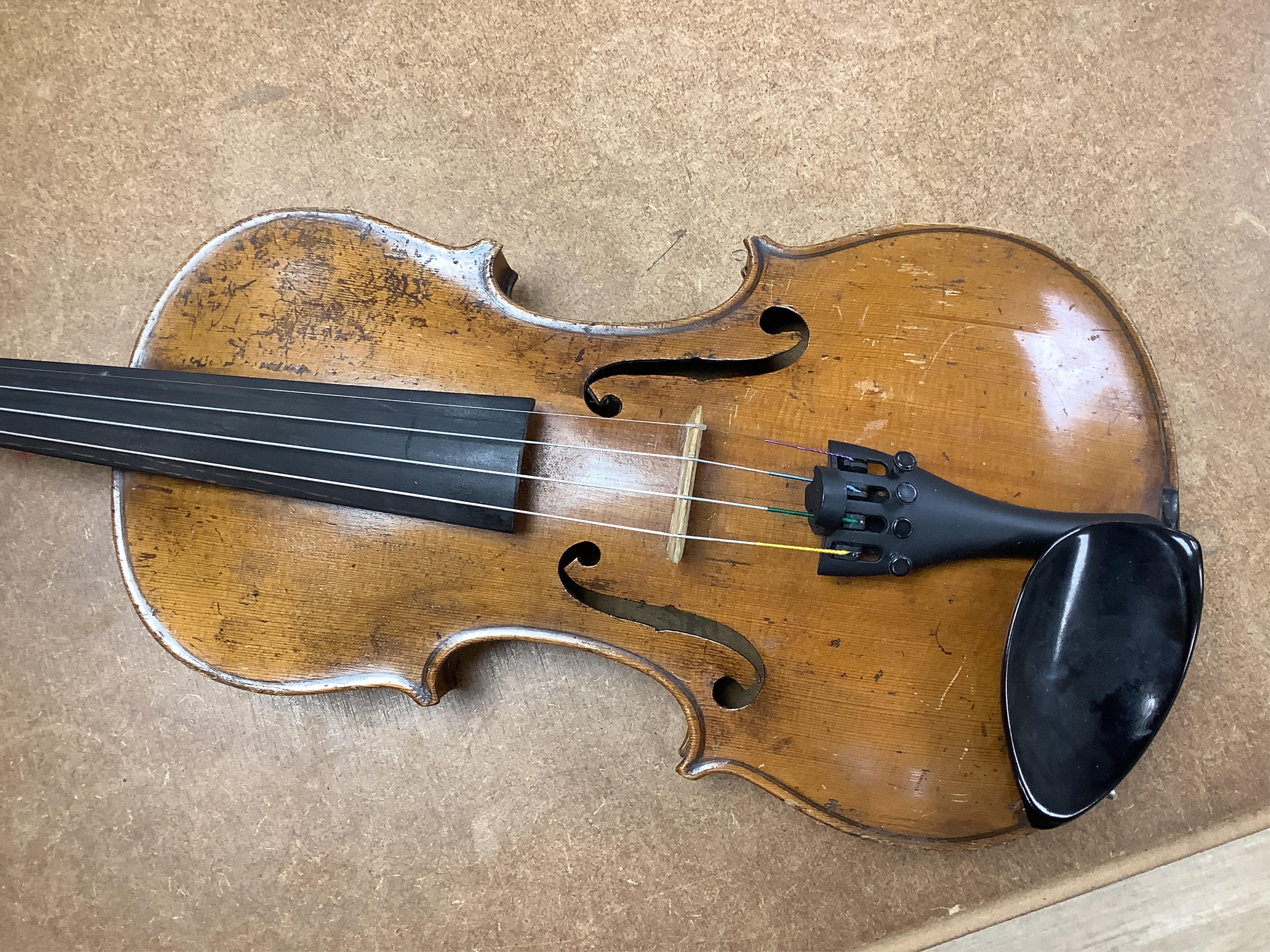 A cased 7/8 size 19th century violin, body 35cm, together with another cased violin, body 35.5cm, both without bows, and a spare case (3)